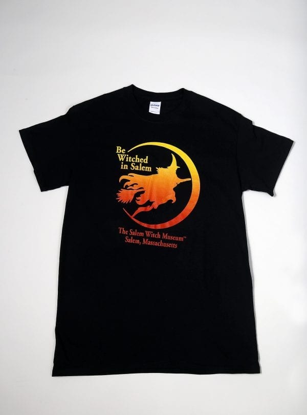 A black t-shirt with an orange witch. Reads "Be Witched in Salem"