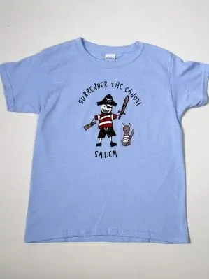 A light blue t-shirt with a stick figure drawing of a pirate and the words "Surrender the candy" and "Salem"