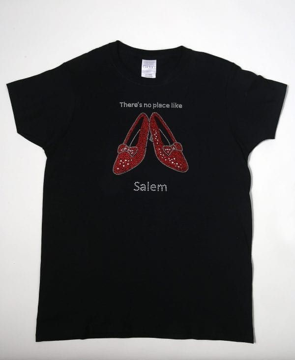 Black t-shirt with rhinestone ruby slippers and text saying "There's no place like Salem"