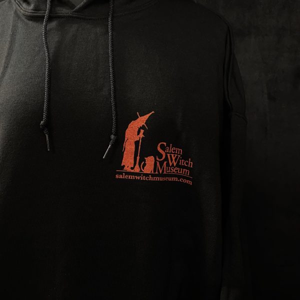 image of front side of black sweatshirt featuring the salem witch museum logo in red.