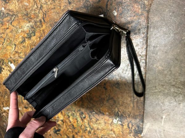 opened purse showing two compartments and a zipped pocked inside